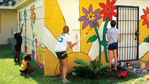 Students painting wall flowers2