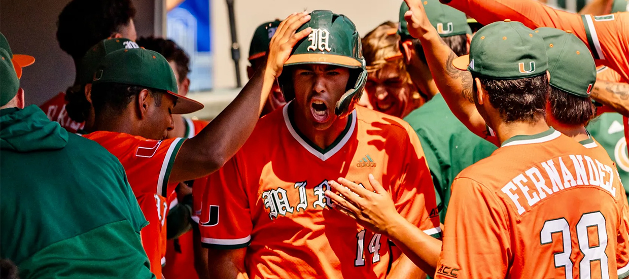 Daniel Cuvet celebrates with his teammates in the dugout after a home run 